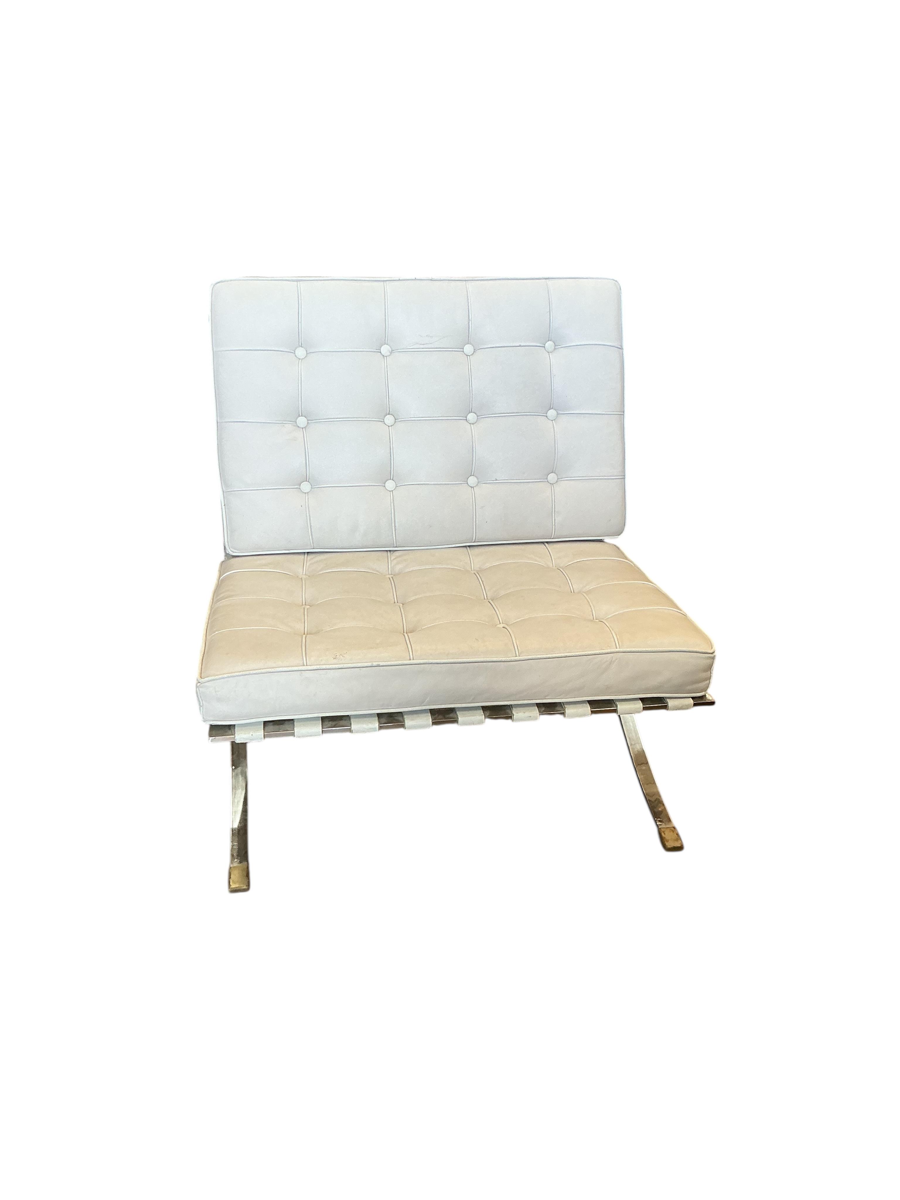 A pair of 'Barcelona' style white leather chairs, width 78cm, depth 80cm, height 82cm and a footstool